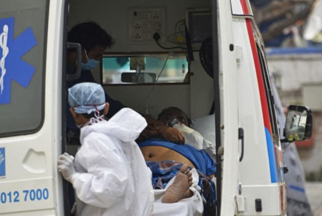 A Covid-19 patient waits inside an ambulance for his admission of a government hospital in Kolkata, India, 22 April, 2021.