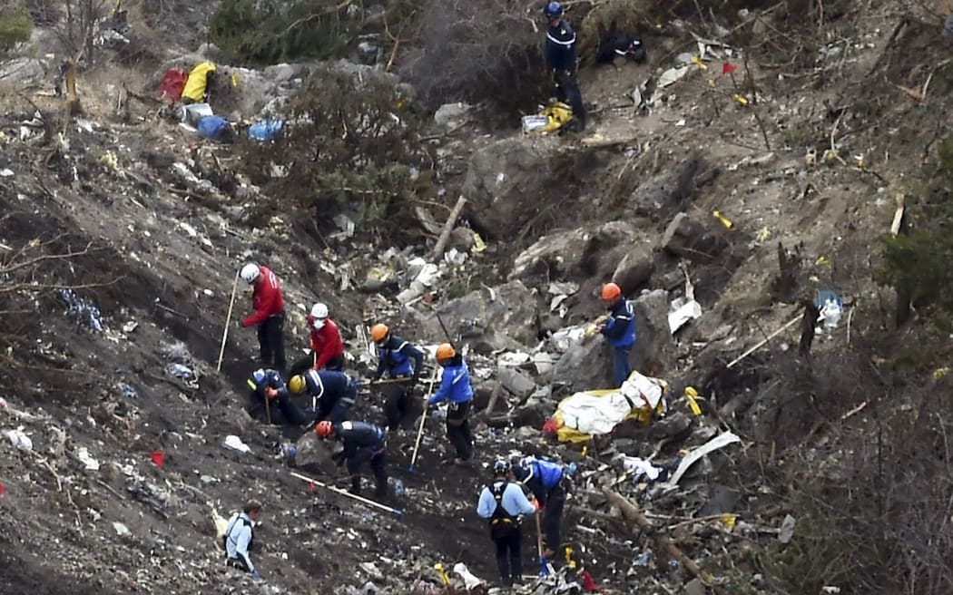 French gendarmes and investigators working in the scattered debris on the crash site of the Germanwings Airbus A320.