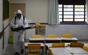 DF - BRASILIA - 02/16/2024 - BRASILIA, OPERATION TO COMBAT DENGUE - A health worker sprays insecticide to kill the Aedes aegypti mosquito to help mitigate a dengue outbreak, at a school in Sao Sebastiao in Brasilia held on 16 February 2024. Photo: Mateus Bonomi/AGIF (Photo by Mateus Bonomi / AGIF / AGIF via AFP)