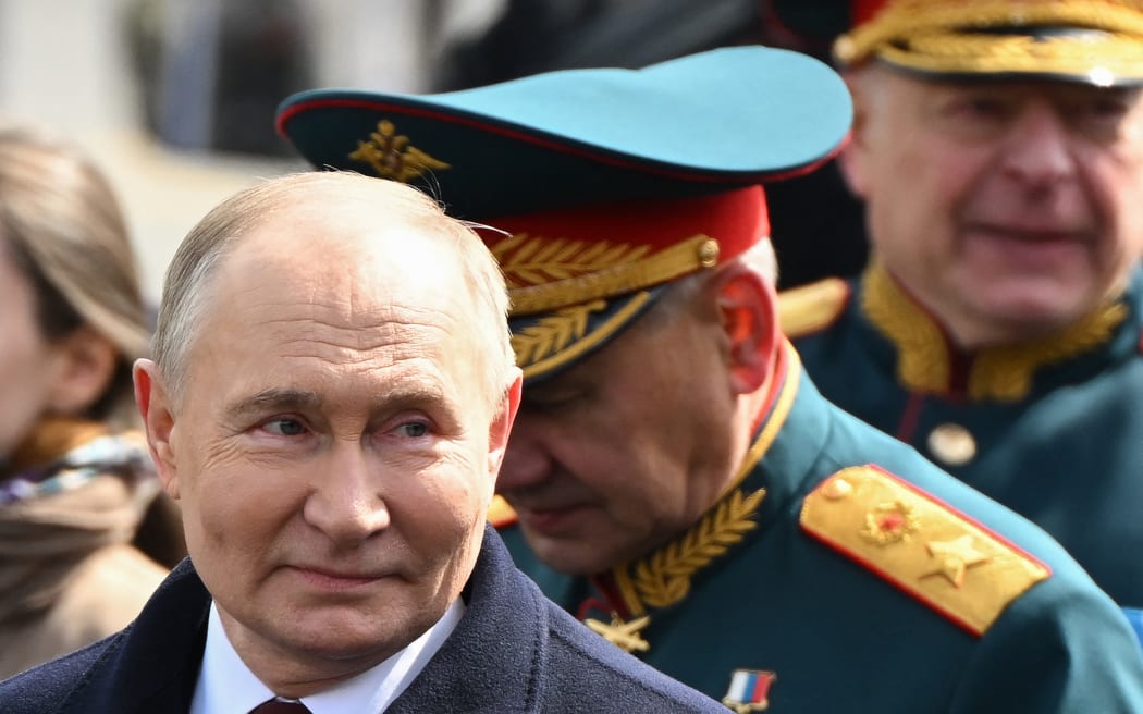 Russia's President Vladimir Putin (L) and Russia's Defence Minister Sergei Shoigu (C) leave Red Square after the Victory Day military parade in central Moscow on 9 May, 2024. Russia celebrates the 79th anniversary of the victory over Nazi Germany in World War II.