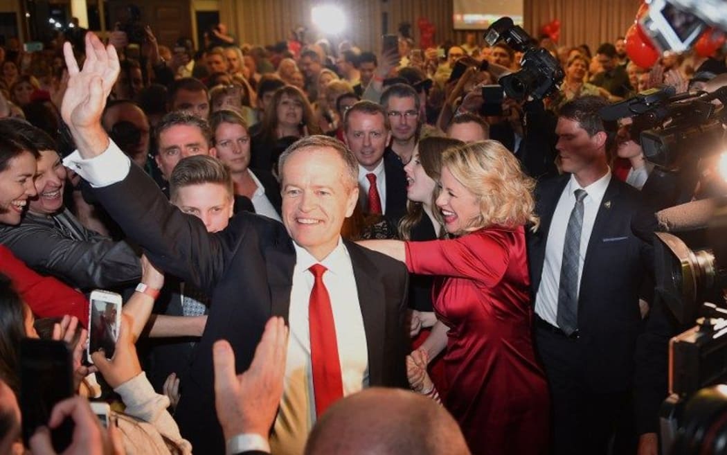 The leader of the Australian Labor Party Bill Shorten waves to party faithful as he arrives to speak about the success of the Labor Party in the Australian Federal Election in Melbourne