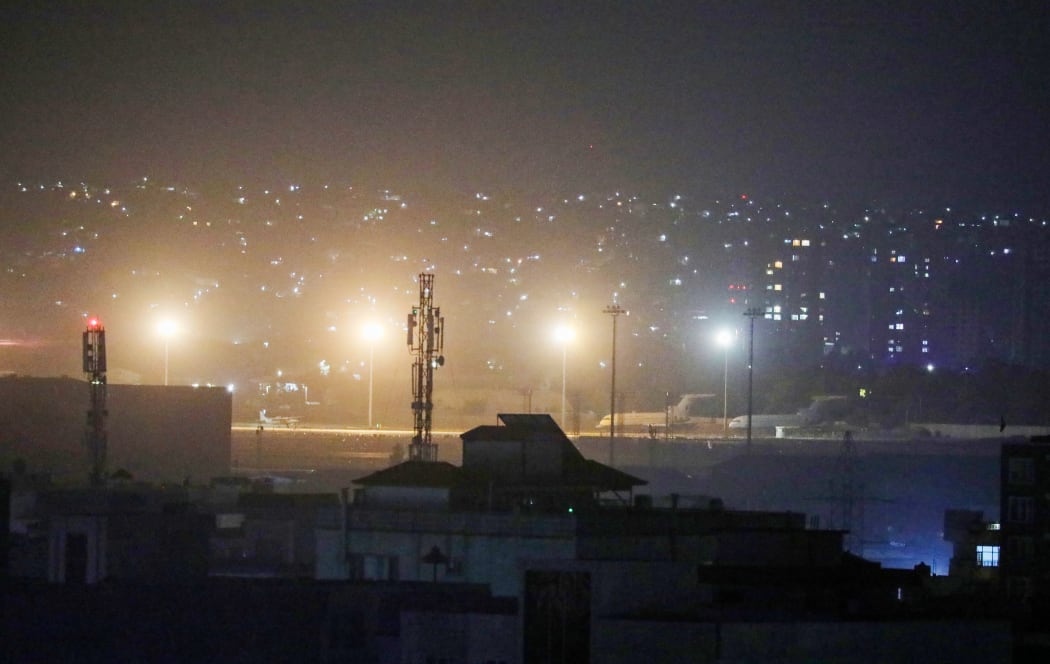 Planes are seen on the tarmac at the airport in Kabul late on August 30, 2021, hours ahead of a US deadline to complete its frenzied withdrawal from Afghanistan.