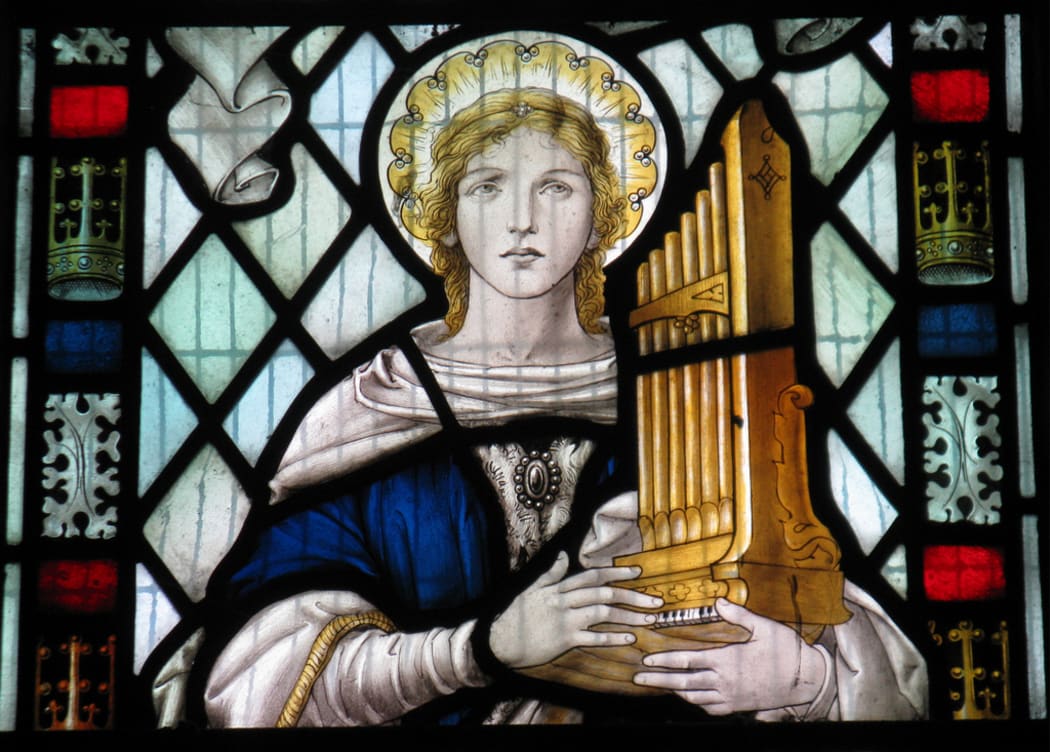 Saint Cecilia in a window in the church of St Mary the Virgin in Little Wymondley in Hertfordshire