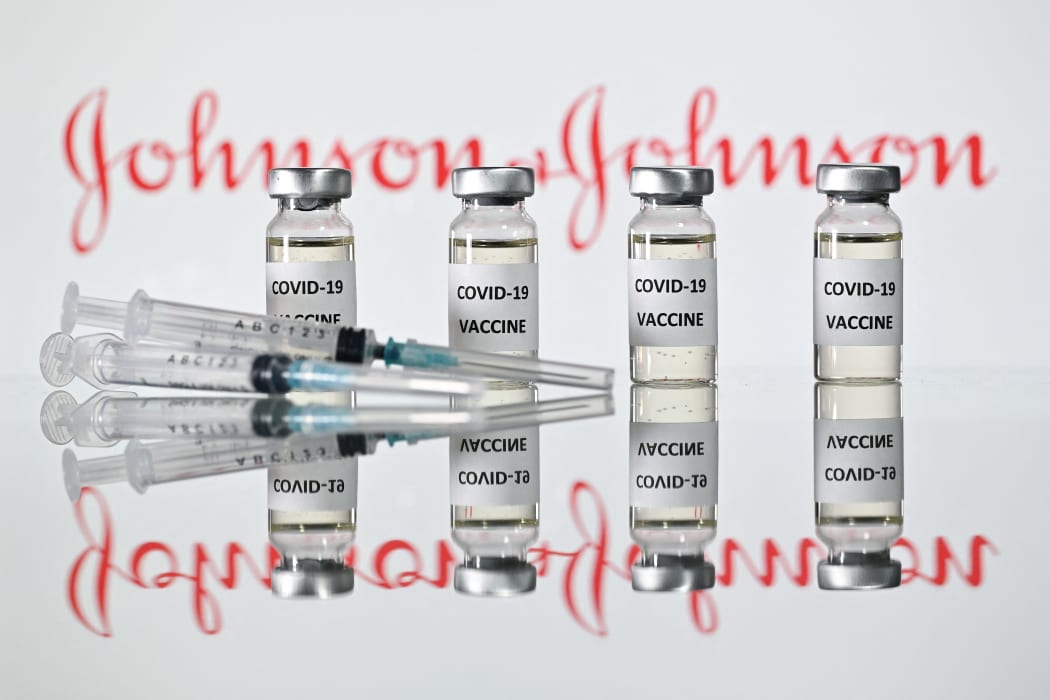 A file photo taken on November 17, 2020 shows vials with Covid-19 Vaccine stickers attached and syringes with the logo of US pharmaceutical company Johnson & Johnson in London.