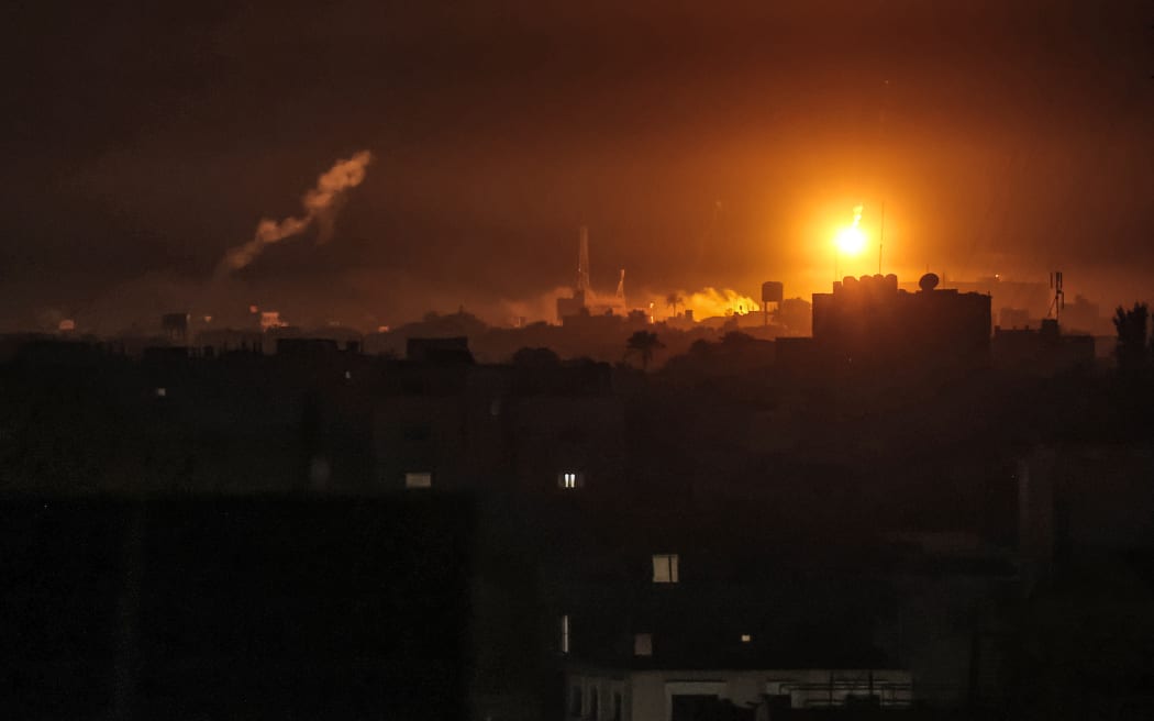 Israeli bombardment lights the skyline of Khan Yunis, pictured from Rafah in the southern Gaza Strip late on January 7, 2024 amid the ongoing conflict between Israel and the Palestinian militant group Hamas. (Photo by AFP)