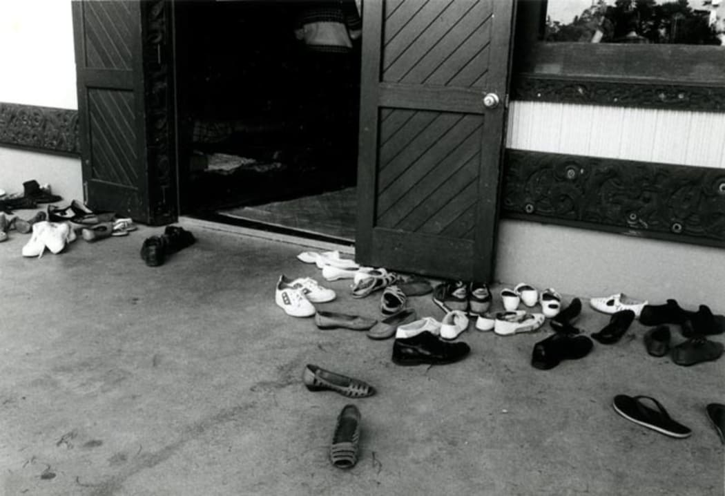 Shoes outside a wharenui are a common sight. Photograph by Gil Hanly, source Te Ara: https://teara.govt.nz/en/photograph/41374/shoes-at-the-door-of-the-wharenui