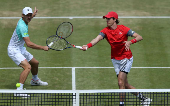 Marcus Daniell (NZL) with a forehand shot at the net as doubles partner Wesley Koolhof (NED) covers.