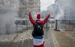 A protester stands in front of police during a demonstration for "freedom, democracy and human rights" organised by the alliance Europeans United in Brussels.