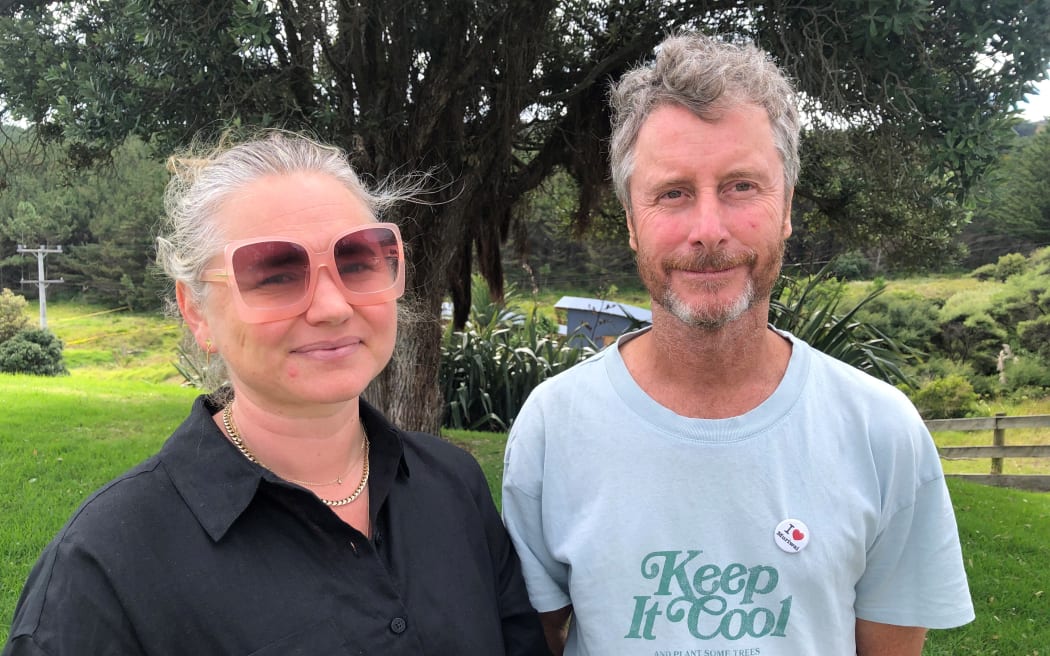 Kat Corbett (left) and Jeremy Jones (right) standing together, outside.