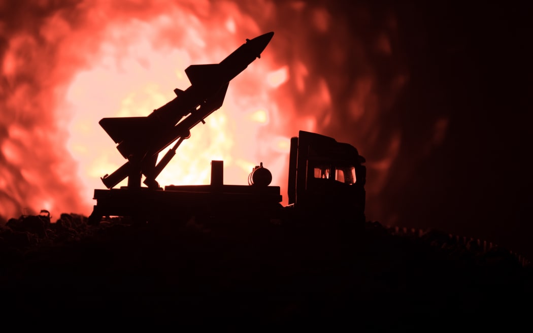 Rocket launch with fire clouds. Battle scene with rocket Missiles with Warhead Aimed at Gloomy Sky at night. Rocket vehicle on War Backgound. Selective focus