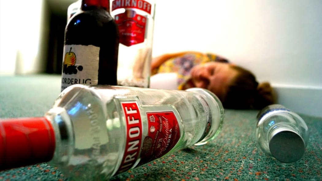 woman passed out with alcohol bottles