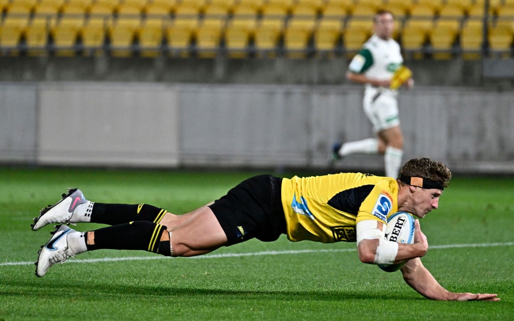 Richard Judd of the Hurricanes dives over to score.