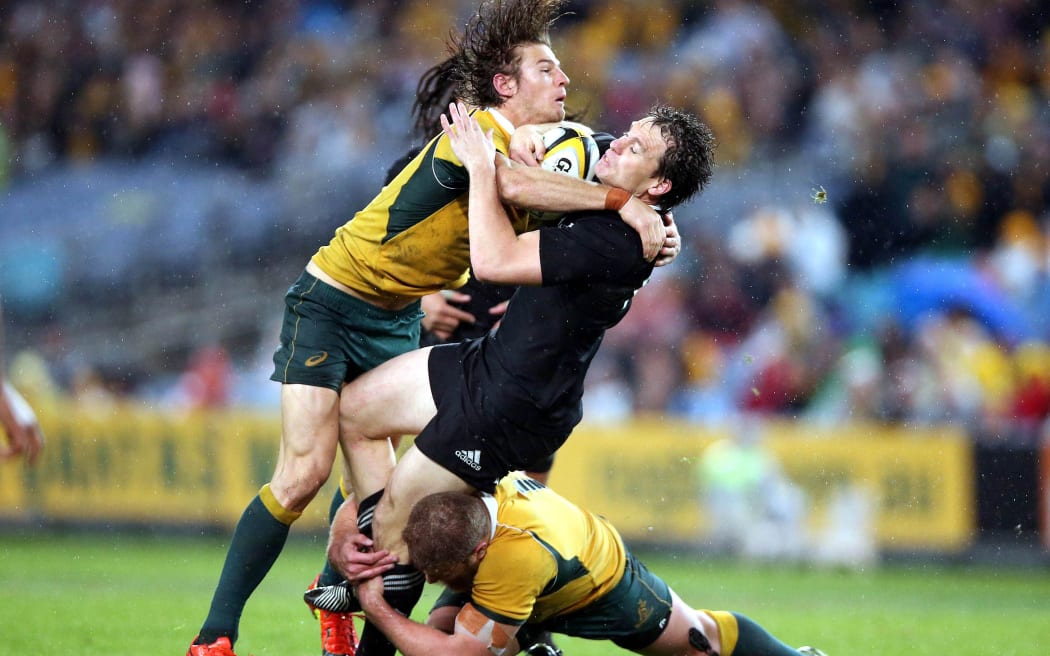 Ben Smith tackled by Rob Horne and James Slipper. Rugby Championship and Bledisloe Cup International Rugby Test Match,Wallabies vs New Zealand, Sydney, 2014.