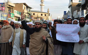 Pakistani Islamists march for the victims of the Peshawar school massacre at a protest in Mansahra.