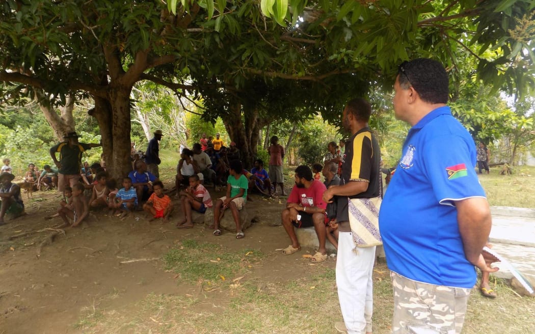 Villagers meet on the Vanuatu island of Ambae as officials tell them to prepare to evacuate.