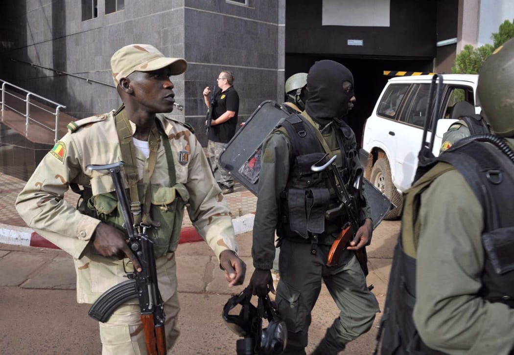 Malian troops take position outside the Radisson Blu hotel in Bamako