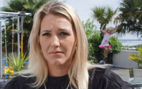 Gillian Bearman said she had no option but to represent herself in a legal case after her part in a trampoline park franchise went south. Daughter Dior plays on the trampoline behind her at home in Richmond.