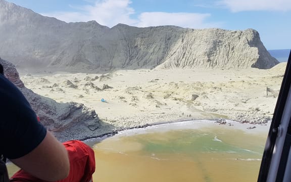 A helicopter assisting in the search and rescue operation at White Island.
