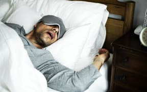 A man sleeping on a bed