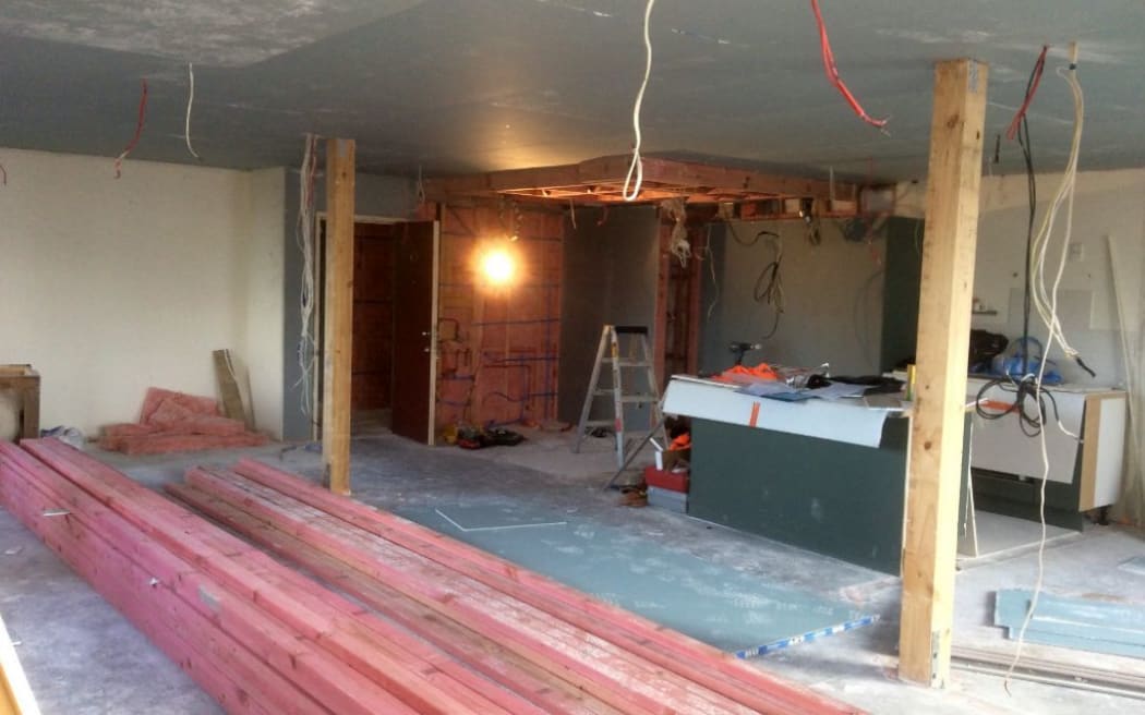 A unit interior with the walls removed for repairs.