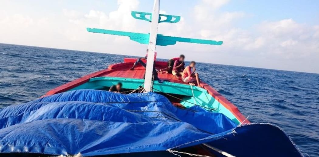 The report says this photo was taken by an asylum seeker and shows a two-deck boat from Indonesia before it was intercepted by Australia in May 2015.