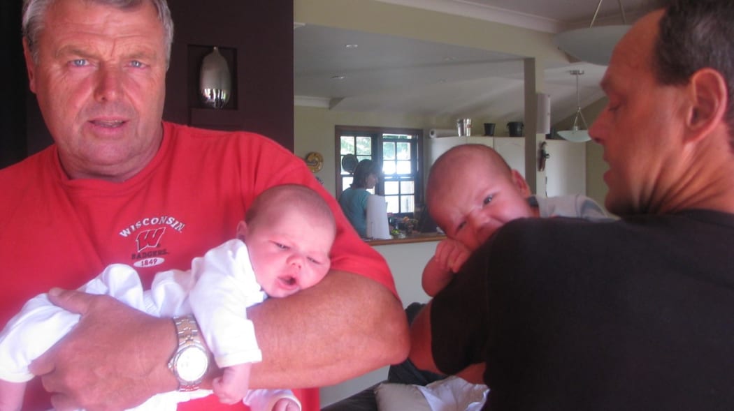 Doug Hopkins (left) holding his grandson Luca, with brother Bruce (right) holding his first grandson, called Charlie.