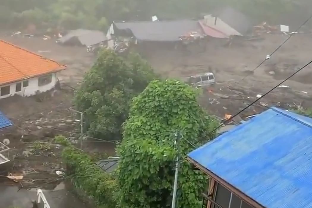 This grab taken from handout video released by a local resident and received via Jiji Press shows mud and debris at the scene of a landslide in Atami city, Japan