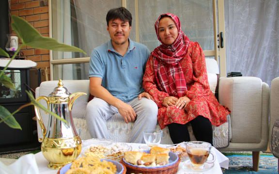 Shookria Basir and Enayatullah Basir, originally from Afghanistan's Ghazni, at their Auckland home with a spread of traditional sweets and tea.