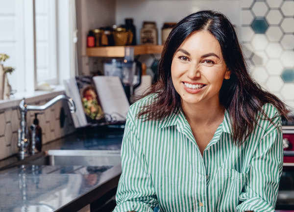 Nadia Lim smiles and wears a green striped shirt.