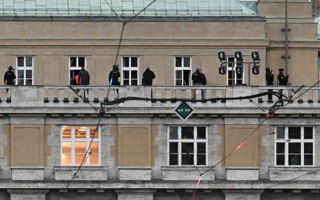 Armed police are seen on the balcony of the Charles University in central Prague, on 21 December, 2023.