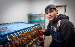 Jerome Hua, a Massey University student, with the sea sausage product he's helped develop.