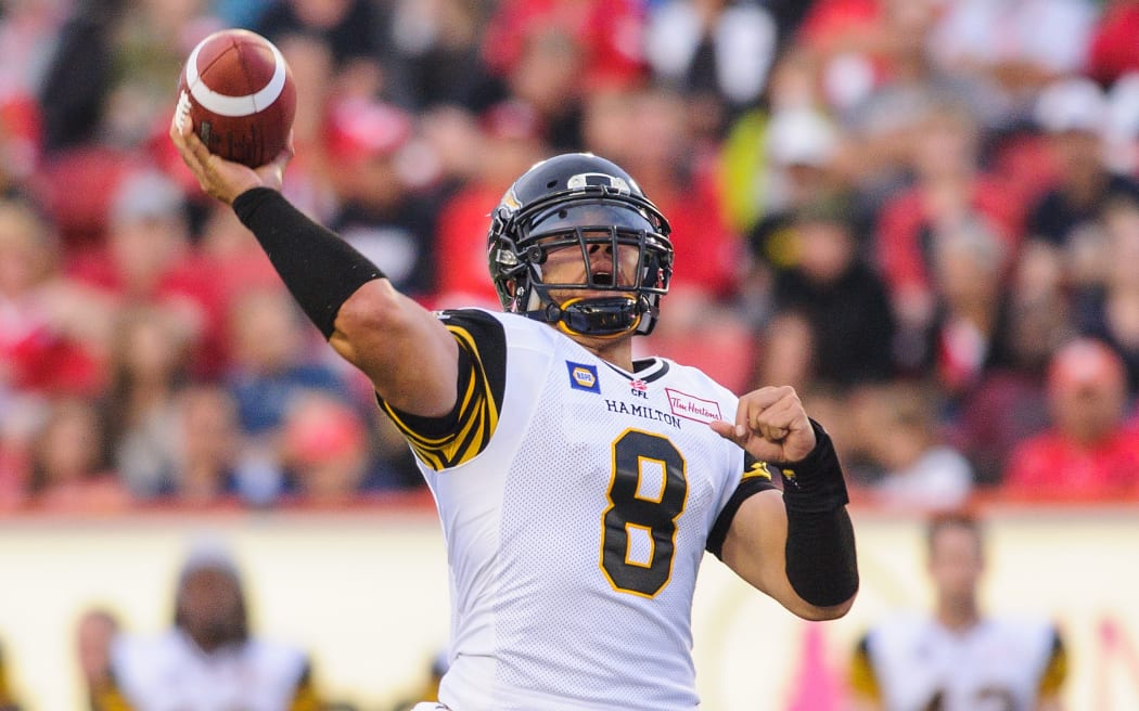 Jeremiah Masoli of the Hamilton Tiger-Cats makes a pass against the Calgary Stampeders.