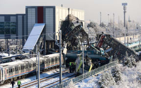 Firefighters and medics try to rescue victims after a high-speed train crashed into a locomotive in Ankara, on December 13, 2018. - Nine people were killed and nearly 50 injured in this train accident. (Photo by ADEM ALTAN / AFP)