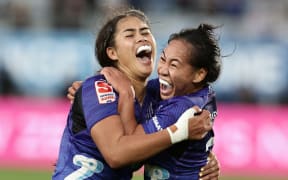 Daynah Nankivell (L) and Kahlia Awa of the Blues celebrate victory in the Super Rugby Aupiki Final against the Chiefs Manawa at Eden Park.