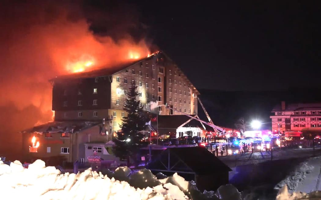 This handout photograph released by the Demiroren News Agency (DHA) on January 21, 2025, shows a fire on the fourth floor of the 11-storey hotel in Bolu's Kartalkaya ski resort. A fire erupted early on January 21, 2025, at a hotel in a popular Turkish ski resort in the central province of Bolu, killing 10 people and injuring 32, the interior minister said.