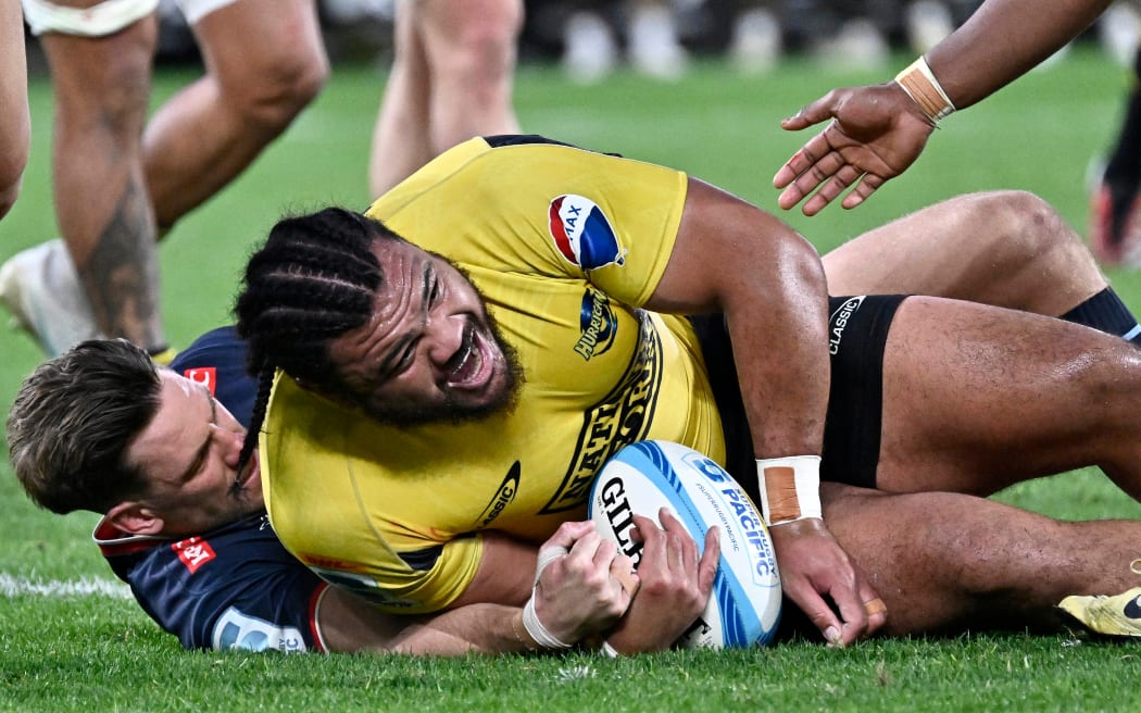 Pasilio Tosi of the Hurricanes dives over to score a try during the Super Rugby Pacific Quarter Final - Hurricanes v Rebels at Sky Stadium.