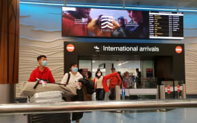 Passengers from international flights at Auckland Airport on Monday 27 January, after flights from Guangzhou and Shanghai had touched down. Some people were wearing masks.