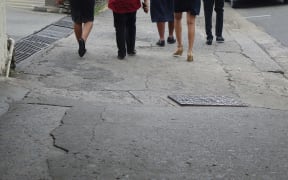 Pedestrians walk in Fiji's capital, Suva.