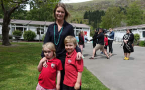 Chelsea Halliwell with her kids Georgie and Flynn, at today's announcement over the future of Redcliffs School.