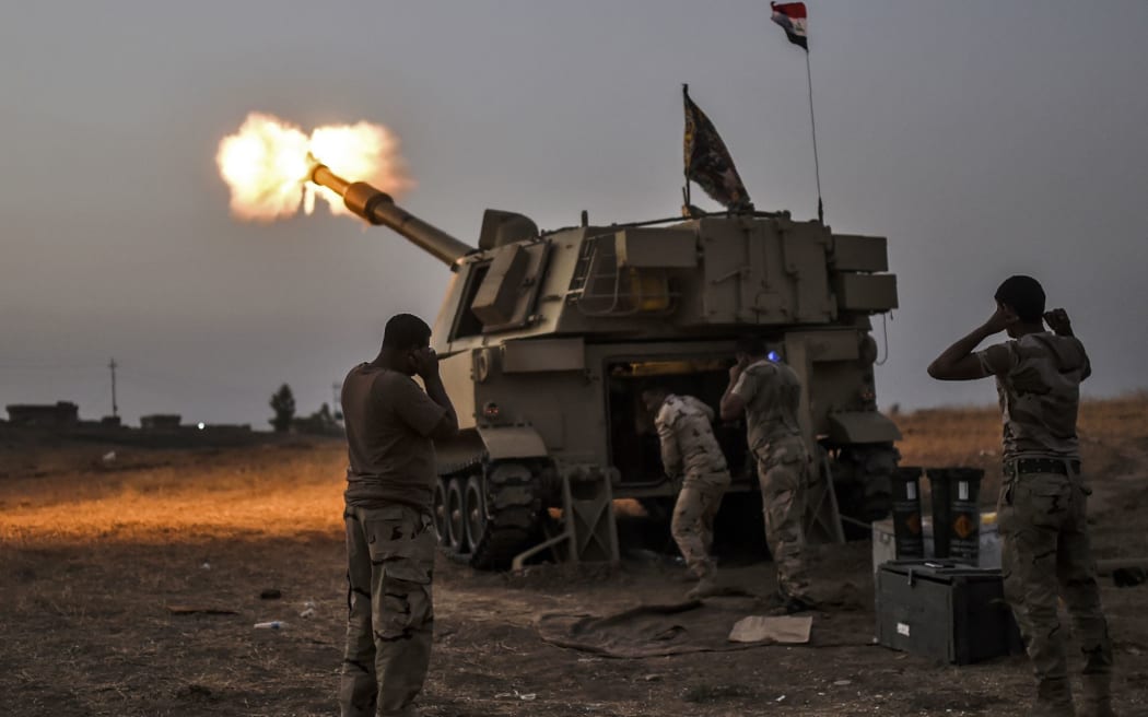 Iraqi forces some 35km from Mosul fire towards the village of Al-Muftuya.