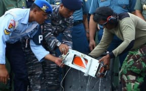 AirAsia QZ8501’s Flight Data Recorder (FDR) is removed from its black box at the at Iskandar Airfield, Pangkalanbun, Indonesia after being retrieved from a depth of 30 to 32 meters in the Java Sea on January 12, 2015.