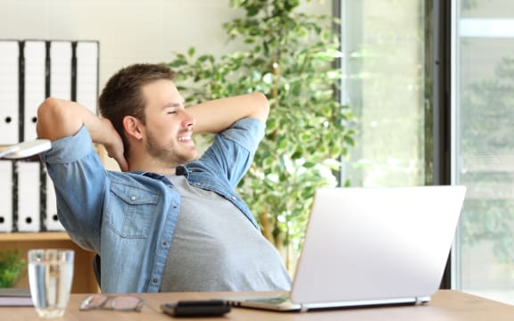 Worker looking outside office window, thinking. (File photo)
