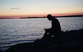 guy on phone at sunset