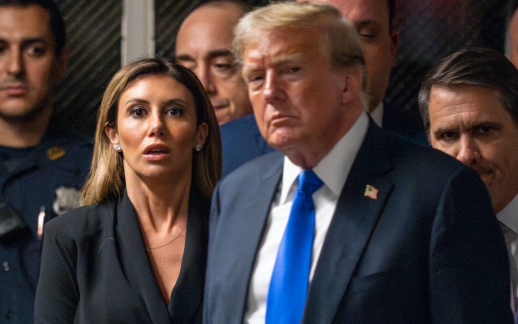 NEW YORK, NEW YORK - MAY 30: Attorney Alina Habba (L) looks on as former U.S. President Donald Trump walks to speak to the media after being found guilty following his hush money trial at Manhattan Criminal Court on May 30, 2024 in New York City. The former president was found guilty on all 34 felony counts of falsifying business records in the first of his criminal cases to go to trial. Trump has now become the first former U.S. president to be convicted of felony crimes.   Steven Hirsch-Pool/Getty Images/AFP (Photo by POOL / GETTY IMAGES NORTH AMERICA / Getty Images via AFP)
