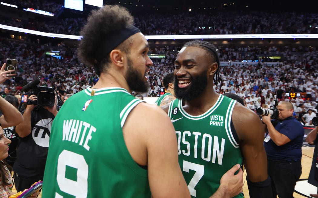 Derrick White (L) and Jaylen Brown of the Boston Celtics react after defeating the Miami Heat 104-103 in game six of the Eastern Conference Finals.