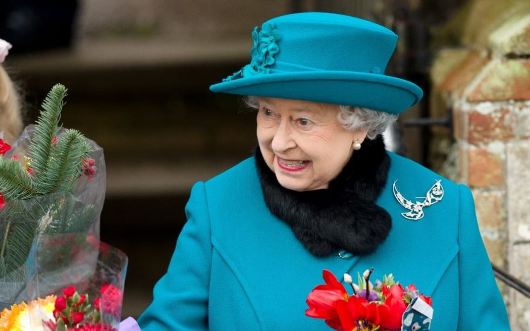 Queen Elizabeth II recieves flowers from children after  Christmas Day church service at St Mary Magdalene Church in Sandringham, Norfolk,  December 25, 2012.