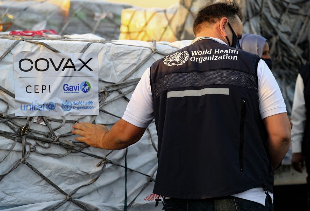 An employee of the World Health Organisation (WHO) supervises the arrival of the first batch of coronavirus vaccines, at Khartoum airport in the Sudanese capital, on 3 March 2121.