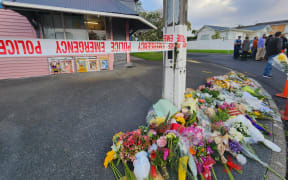 Flowers outside Rose Cottage Superette in Sandringham after fatal stabbing of a worker