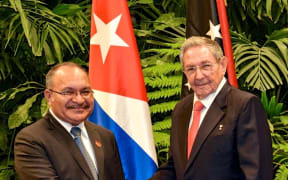 PNG Prime Minister Peter O'Neill (left) extended condolences to Cuba's President Raul Castro (right) on the death of his brother, former Cuban leader Fidel Castro.