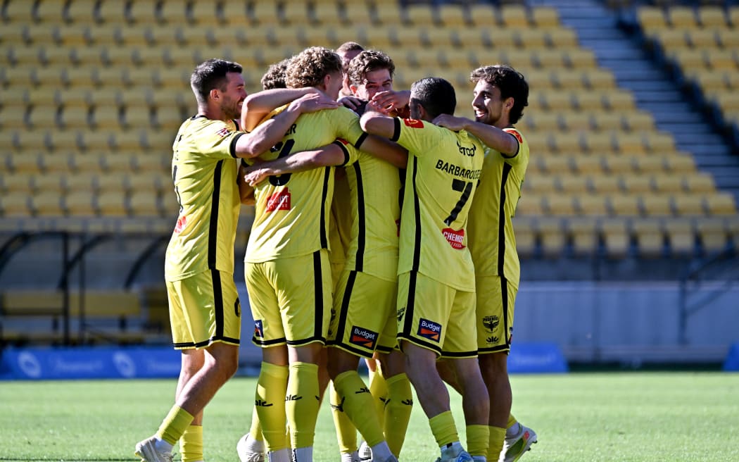 Paulo Retre and Wellington Phoenix team-mates celebrate his goal during their A-League match in Wellington, Dec 28, 2024.